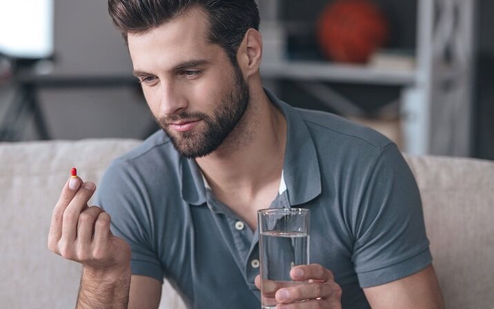 a man drinks a pill to enlarge the head of the penis